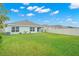 Large backyard with grassy area and a home at 16758 Sunburst Lake St, Wimauma, FL 33598