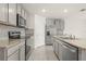 Modern kitchen featuring gray cabinets and granite countertops at 16758 Sunburst Lake St, Wimauma, FL 33598