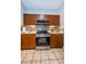 Kitchen with stainless steel appliances and wood cabinets at 2200 Tuscany Trce # 21, Palm Harbor, FL 34683