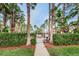 Gated entrance to the community pool area with lush landscaping at 2200 Tuscany Trce # 21, Palm Harbor, FL 34683