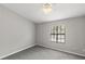 Simple bedroom with grey carpet and window with blinds at 2601 Brigadoon Dr, Clearwater, FL 33759