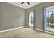 Cozy bedroom featuring carpet flooring and windows dressed with blue curtains at 10022 Bentley Way, Tampa, FL 33626