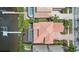 Aerial view of a home with a terracotta roof, screened pool, and private dock at 1233 Acappella Ln, Apollo Beach, FL 33572