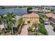 A bright yellow two-story home with tropical landscaping, a terracotta roof, and double balconies at 1233 Acappella Ln, Apollo Beach, FL 33572