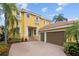 Elegant home featuring a spacious driveway and a three-car garage at 1233 Acappella Ln, Apollo Beach, FL 33572