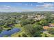 Aerial view of the neighborhood near a lake at 251 Hidden Brook Dr # 102C, Palm Harbor, FL 34683