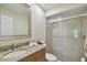 Bathroom featuring a granite vanity and a glass-enclosed tiled shower at 251 Hidden Brook Dr # 102C, Palm Harbor, FL 34683
