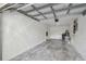 Spacious garage featuring concrete floors and overhead storage at 251 Hidden Brook Dr # 102C, Palm Harbor, FL 34683