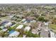 Neighborhood aerial view of the home near a baseball field and mature trees at 272 Diogenes St, Dunedin, FL 34698