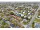 An aerial view shows a tranquil residential community with well-maintained streets and homes at 272 Diogenes St, Dunedin, FL 34698