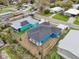 Aerial view of the home with an extended patio in a quiet neighborhood at 272 Diogenes St, Dunedin, FL 34698