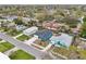 Aerial view of the home, nestled in a residential neighborhood with mature trees at 272 Diogenes St, Dunedin, FL 34698