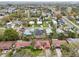 Expansive aerial view of a residential neighborhood with mature trees and varied home styles at 272 Diogenes St, Dunedin, FL 34698