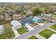 Aerial view of the home, nestled in a residential neighborhood with mature trees at 272 Diogenes St, Dunedin, FL 34698