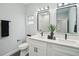 Modern bathroom featuring dual sinks with white cabinets, quartz countertops, and black fixtures at 272 Diogenes St, Dunedin, FL 34698