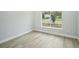 Bedroom featuring a large window, tile flooring, and light, neutral paint at 272 Diogenes St, Dunedin, FL 34698