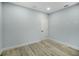 Bedroom featuring neutral paint, hardwood floors, and a door at 272 Diogenes St, Dunedin, FL 34698