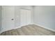 Bedroom with hardwood floors, closet, and door at 272 Diogenes St, Dunedin, FL 34698