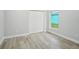 Bedroom with hardwood floors, window, and closet at 272 Diogenes St, Dunedin, FL 34698