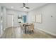 Bright dining room features hardwood floors, modern ceiling fan and a large window at 272 Diogenes St, Dunedin, FL 34698