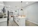 Open kitchen showcasing a large island, modern white cabinets and stainless steel appliances at 272 Diogenes St, Dunedin, FL 34698