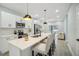 Kitchen featuring an island with bar seating, white cabinets, and stainless steel appliances at 272 Diogenes St, Dunedin, FL 34698