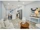 Open-concept kitchen and living room featuring a breakfast bar and modern stainless steel appliances at 272 Diogenes St, Dunedin, FL 34698