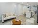 Bright living room flows to kitchen with a breakfast bar and stainless steel appliances at 272 Diogenes St, Dunedin, FL 34698