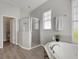 Bright bathroom featuring a walk-in shower and soaking tub at 528 Islebay Dr, Apollo Beach, FL 33572