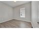 Simple bedroom with wood-look flooring and window at 528 Islebay Dr, Apollo Beach, FL 33572