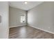 Bright bedroom featuring wood-look floors and a large window at 528 Islebay Dr, Apollo Beach, FL 33572