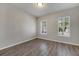 Bright bedroom with wood-look floors and window shutters at 528 Islebay Dr, Apollo Beach, FL 33572