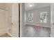 Spacious bedroom with wood-look flooring and two windows at 528 Islebay Dr, Apollo Beach, FL 33572