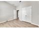 Simple bedroom with wood-look floors and double doors at 528 Islebay Dr, Apollo Beach, FL 33572