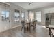 Bright dining area with wood table, neutral decor, and access to kitchen at 528 Islebay Dr, Apollo Beach, FL 33572