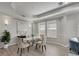 Elegant dining room with glass table, neutral decor, and hardwood floors at 528 Islebay Dr, Apollo Beach, FL 33572