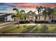 Charming two-story house with a front porch and palm trees at 528 Islebay Dr, Apollo Beach, FL 33572