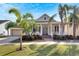 House exterior featuring a front porch and palm trees at 528 Islebay Dr, Apollo Beach, FL 33572