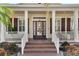 Front porch with wicker chairs and a side table at 528 Islebay Dr, Apollo Beach, FL 33572