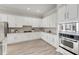 Modern kitchen with white cabinets, granite countertops, and stainless steel appliances at 528 Islebay Dr, Apollo Beach, FL 33572