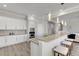 Modern kitchen with white cabinets and a large island at 528 Islebay Dr, Apollo Beach, FL 33572