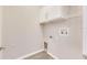 Bright laundry room with white cabinets and wire shelving at 528 Islebay Dr, Apollo Beach, FL 33572