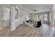 Open living area with hardwood floors and access to hallway at 528 Islebay Dr, Apollo Beach, FL 33572