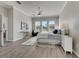 King-size bed in spacious main bedroom with plenty of natural light at 528 Islebay Dr, Apollo Beach, FL 33572
