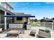 Outdoor kitchen with built-in grill, bar seating, and patio furniture at 528 Islebay Dr, Apollo Beach, FL 33572