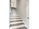 Modern staircase with gray wood and white risers at 528 Islebay Dr, Apollo Beach, FL 33572