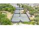 Aerial view of four well-maintained tennis courts at 528 Islebay Dr, Apollo Beach, FL 33572