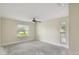 Bright bedroom with large window and ceiling fan at 251 Hidden Brook Dr # 102C, Palm Harbor, FL 34683