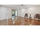 Living room with hardwood floors, two armchairs, and a view of a screened porch at 251 Hidden Brook Dr # 102C, Palm Harbor, FL 34683