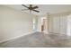 Spacious bedroom with private bathroom access and ceiling fan at 251 Hidden Brook Dr # 102C, Palm Harbor, FL 34683